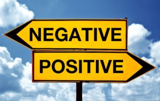 A yellow sign that says negative and positive